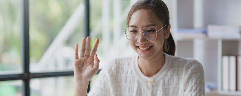 Beautiful young Asian business woman sit on a laptop video confe