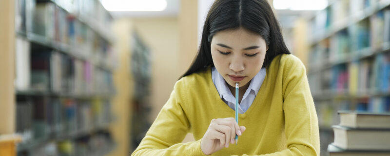 Student studying at library.