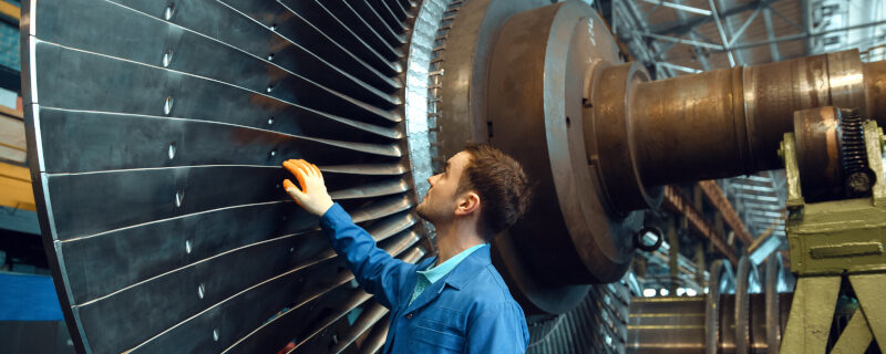 Engineer checks turbine impeller vanes, factory